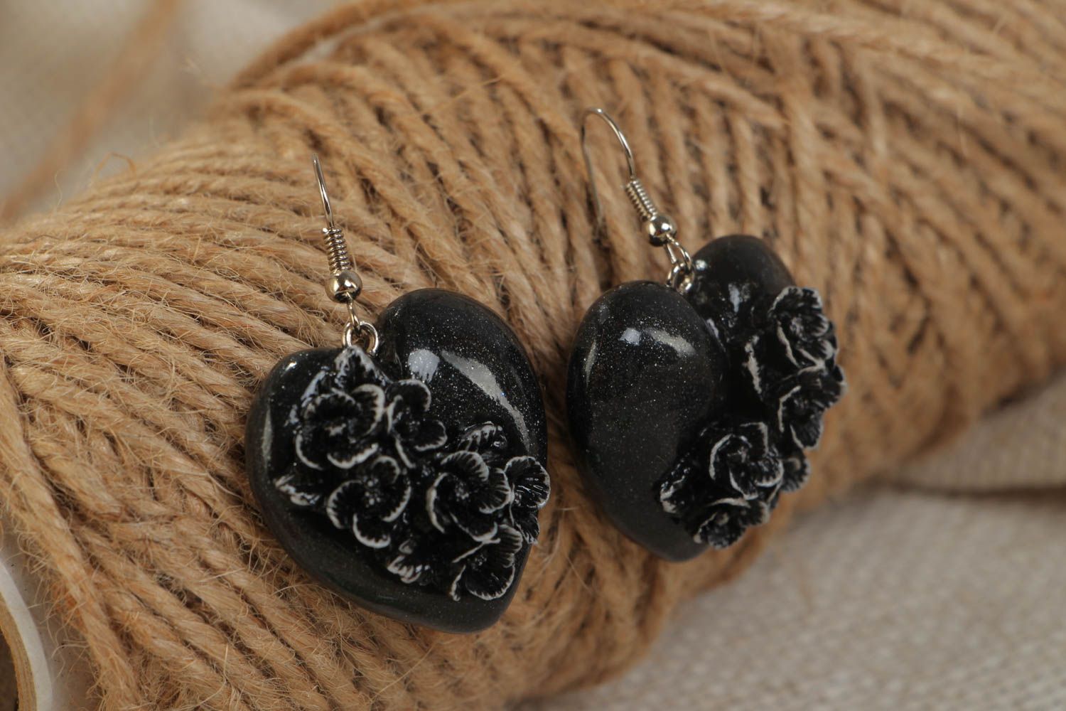 Handmade small polymer clay black heart shaped dangling earrings with flowers photo 1