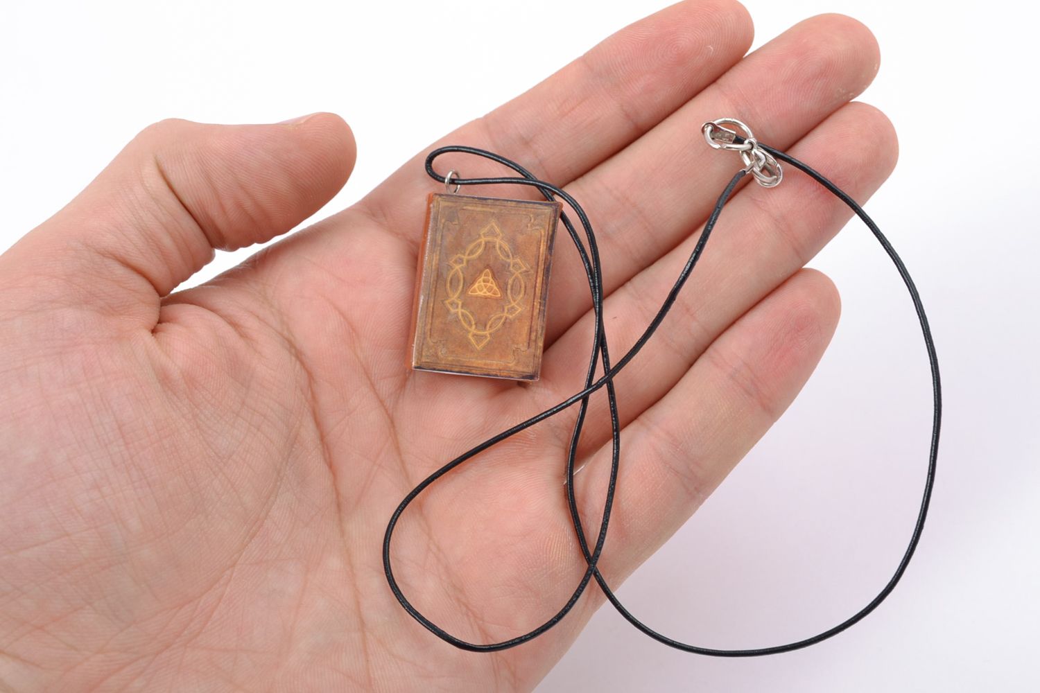 Polymer clay pendant in the shape of book with leather cord photo 1