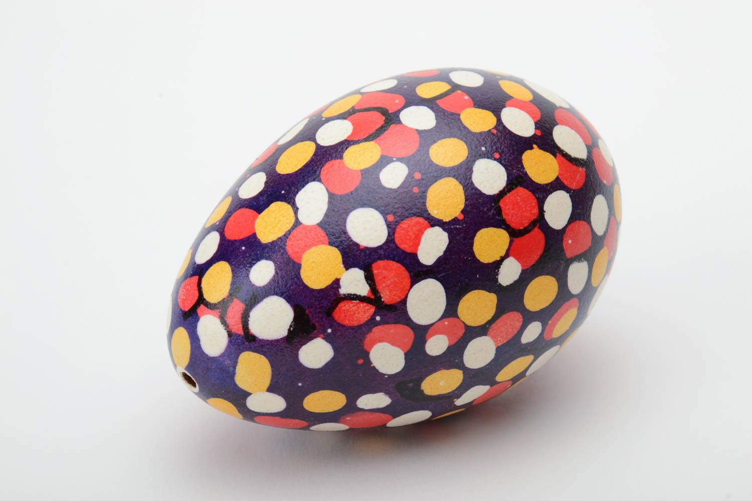 Handmade unusual Easter egg with colorful polka dot pattern on dark background photo 2