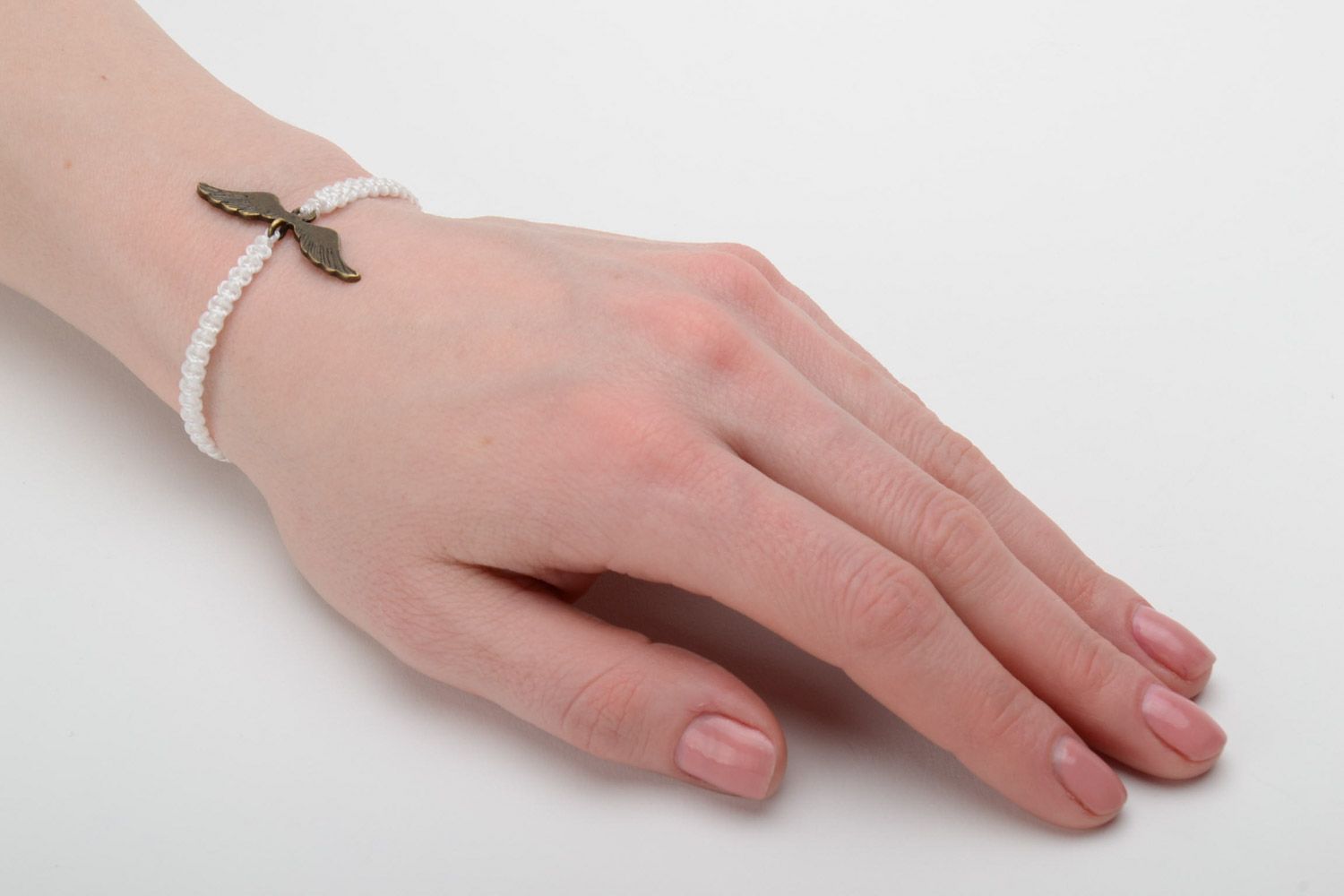 Handmade white women's woven thread bracelet with metal charm photo 2