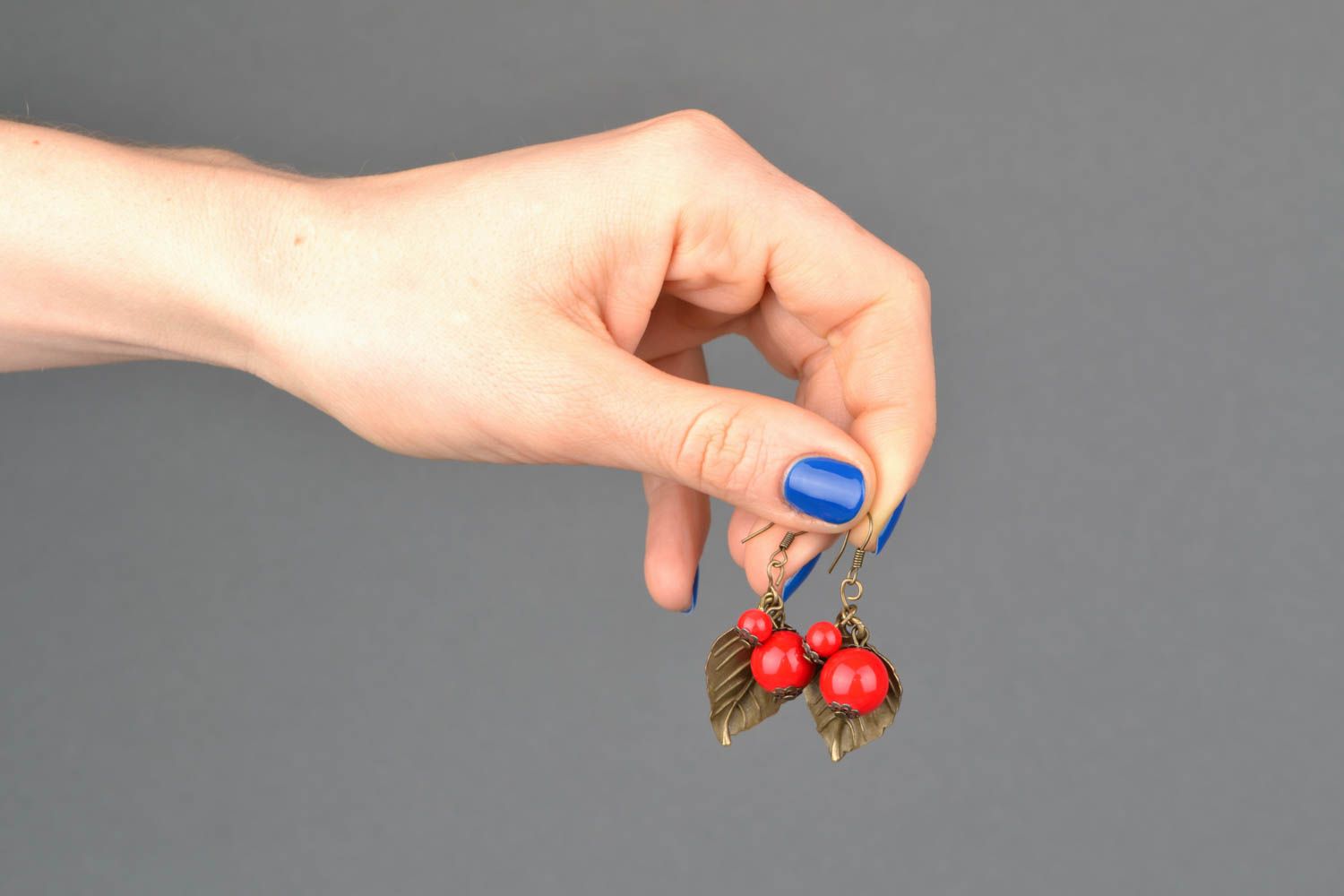 Metal leaf-earrings with ceramic beads of coral color photo 2