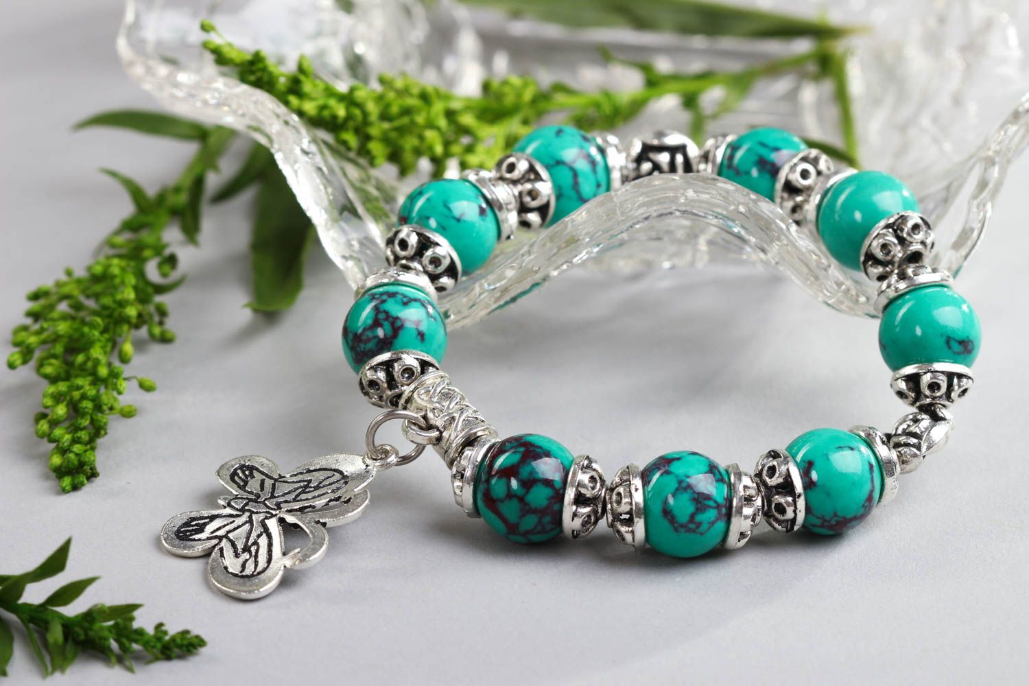 Natural turquoise stone beaded wrist bracelet with metal charms and central butterfly charm photo 1