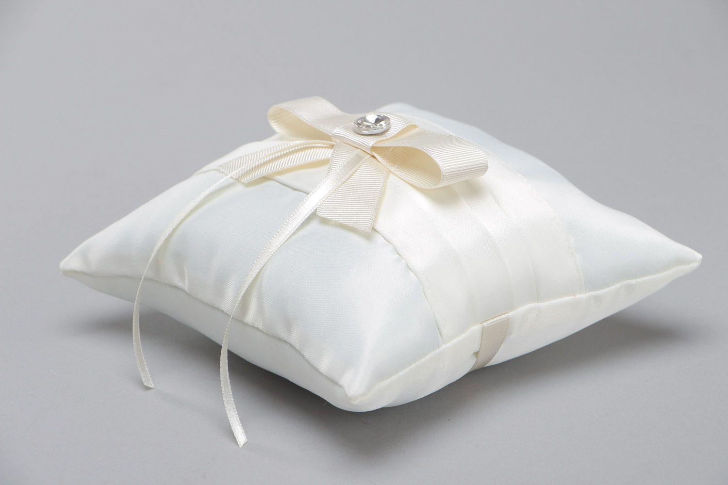Tender handmade wedding ring pillow sewn of ivory-colored satin fabric with bow photo 3