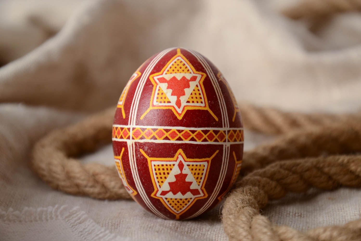 Handmade decorative Easter egg painted with wax in dark brown color palette photo 1