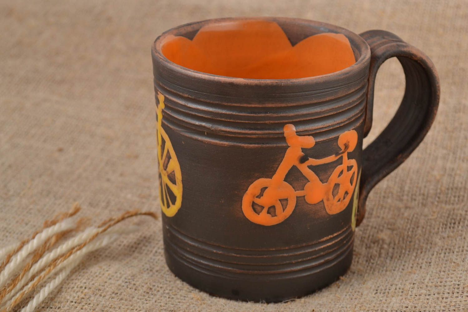 8 oz brown and orange ceramic coffee cup with bicycle patter and handle photo 1