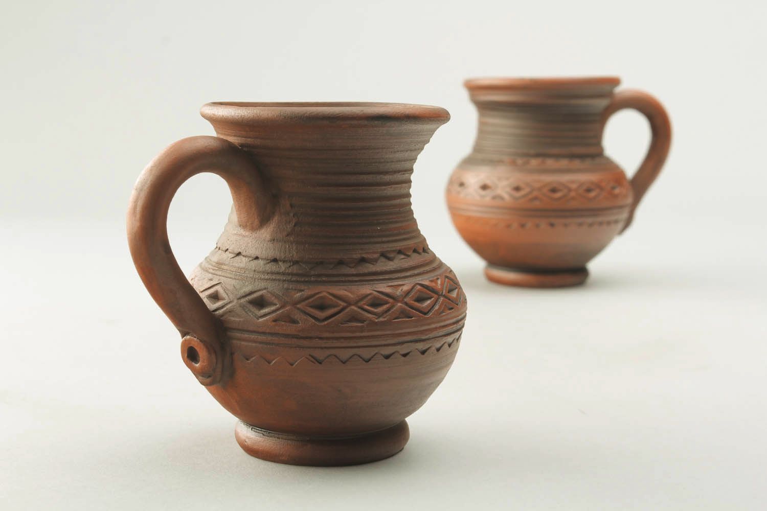 8 oz natural clay cup in the shape of the pitcher with handle and rustic pattern photo 1