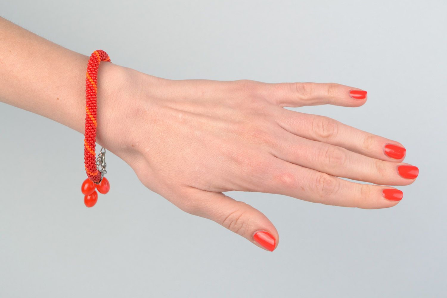 Handmade designer wrist bracelet woven of Czech beads in red color palette photo 1