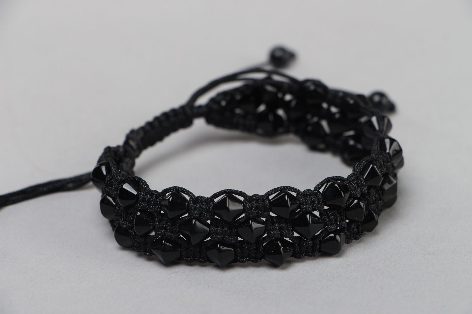 Handmade laconic friendship bracelet woven of black cord and beads for women photo 1