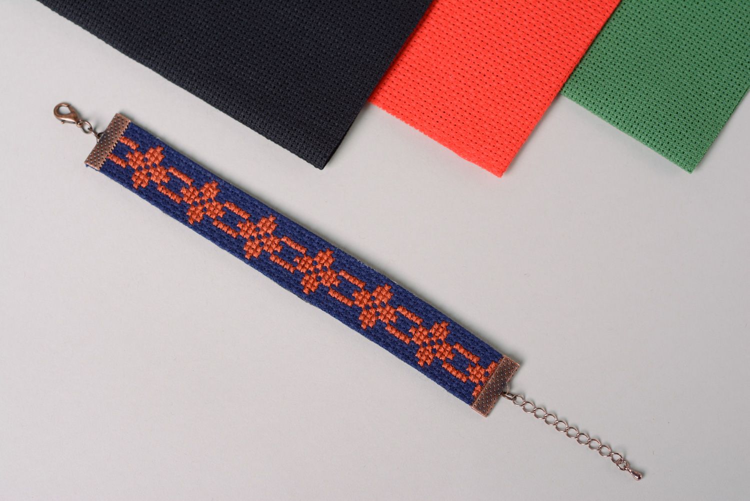 Handmade women's wrist bracelet with ethnic embroidery on dark blue background photo 1