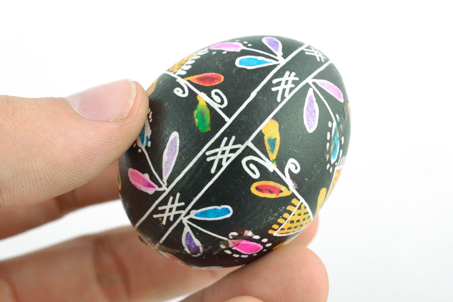 Handmade Easter egg with floral ornament on black background painted with wax photo 2