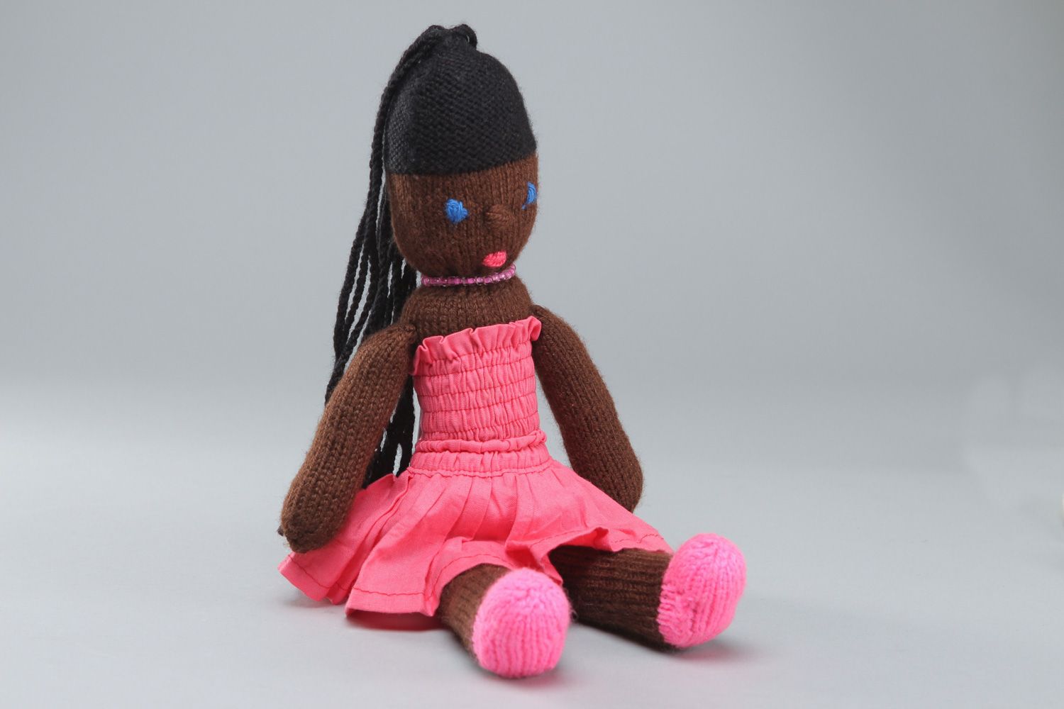 Handmade soft toy knitted of acrylic threads Mulatto in pink dress for little girl photo 1