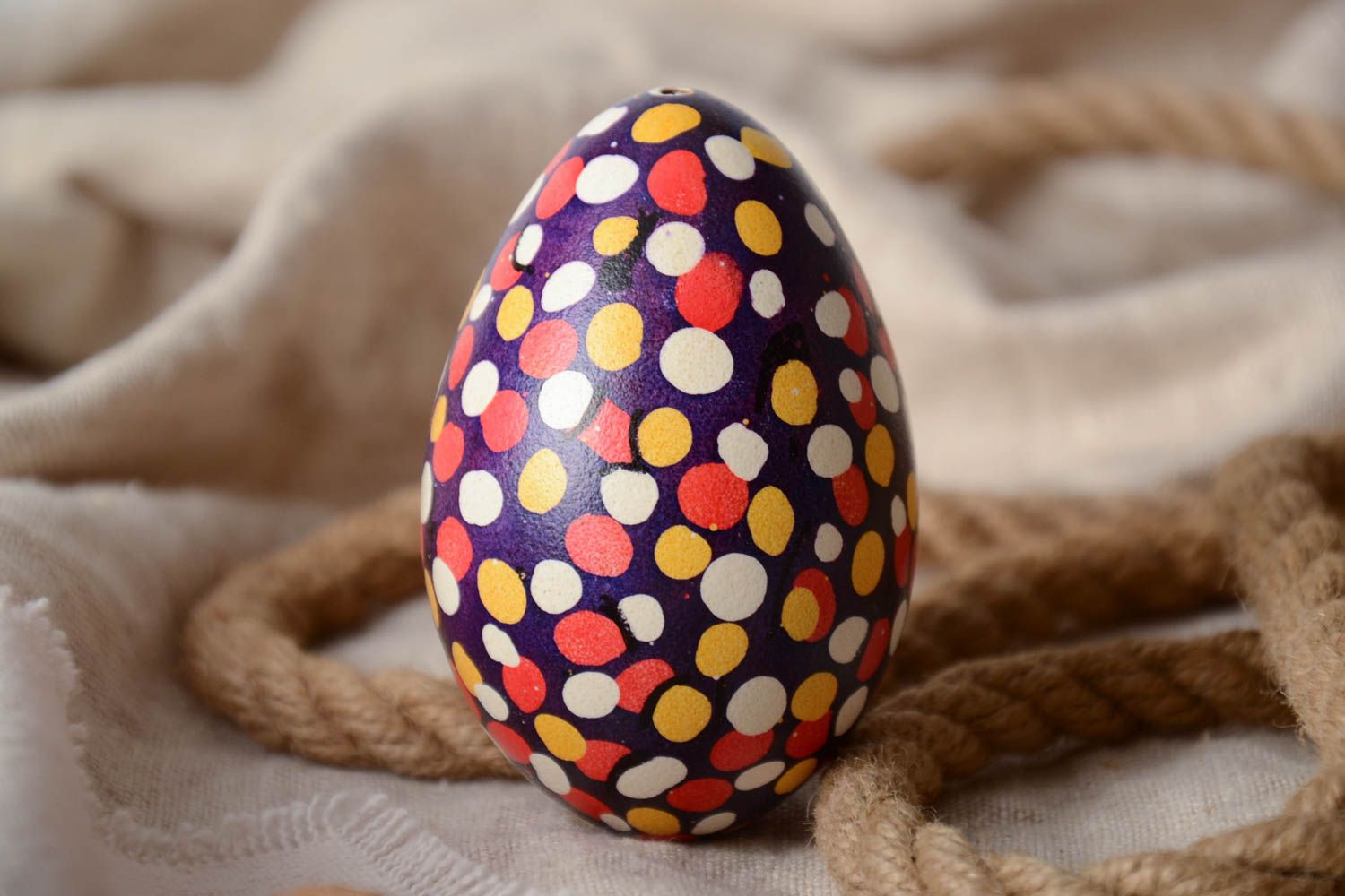 Handmade unusual Easter egg with colorful polka dot pattern on dark background photo 1