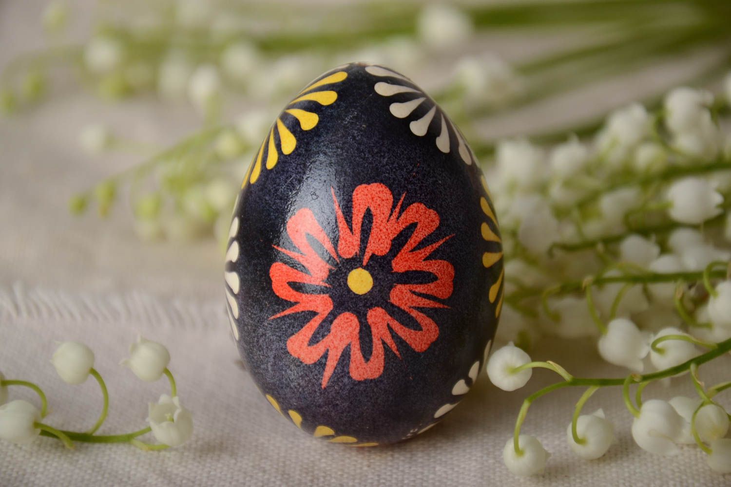Handmade Easter egg painted with Lemkiv floral ornament on dark background photo 1
