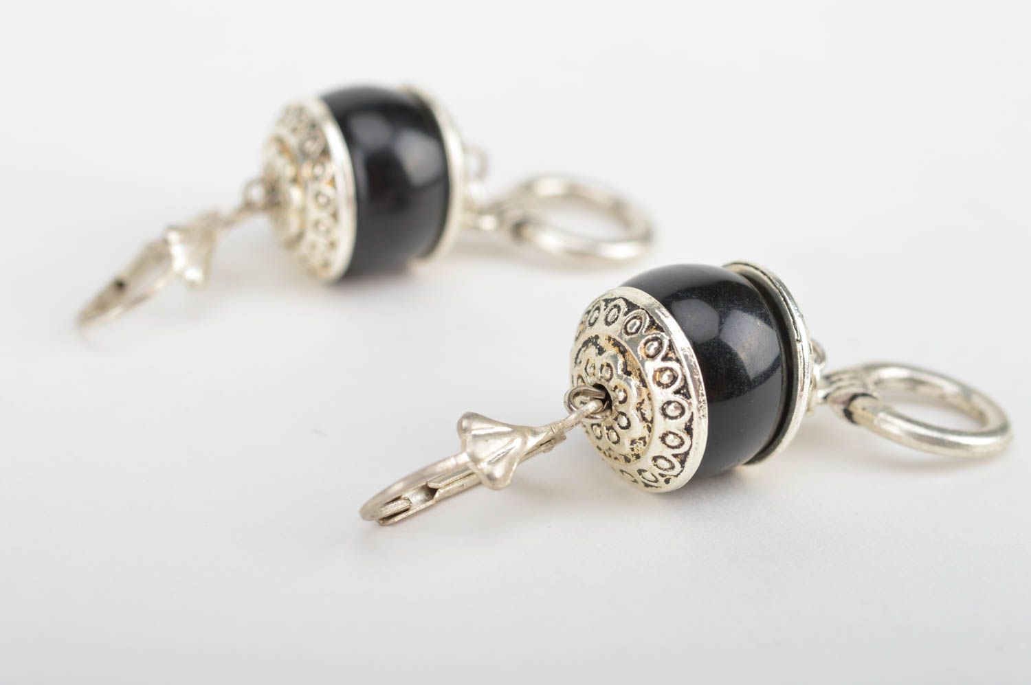 Handmade silver colored metal dangle earrings with black beads in ethnic style photo 2