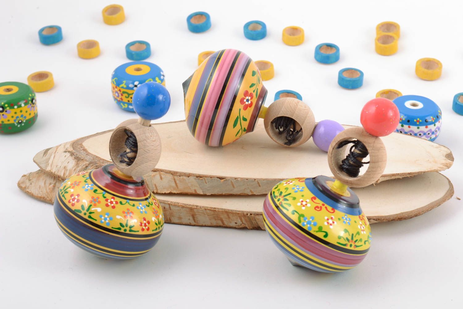 Handmade painted wooden toys set 3 pieces spinning tops with rings and strings photo 1
