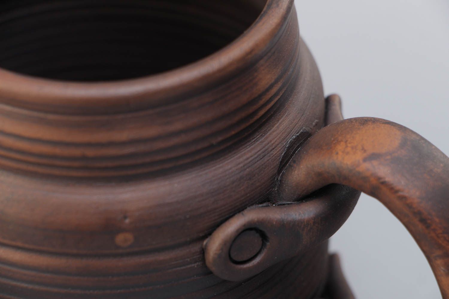 Handmade decorative dark brown ceramic beer mug kilned with milk in ethnic style photo 3