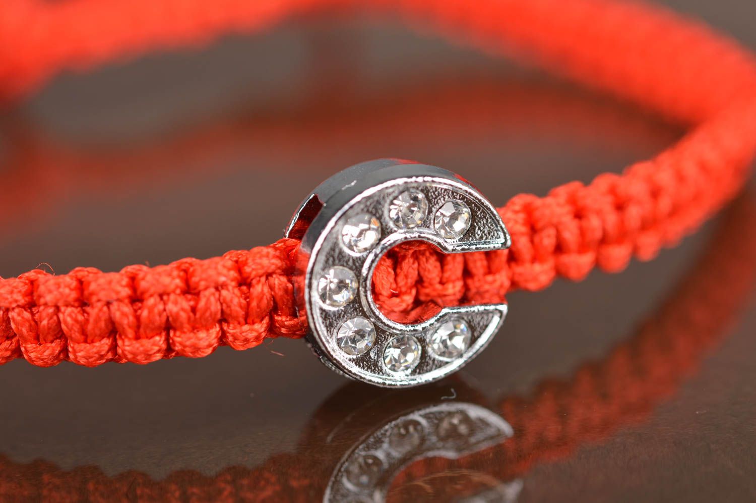 Handmade woven friendship bracelet made of red cords with letter C photo 3