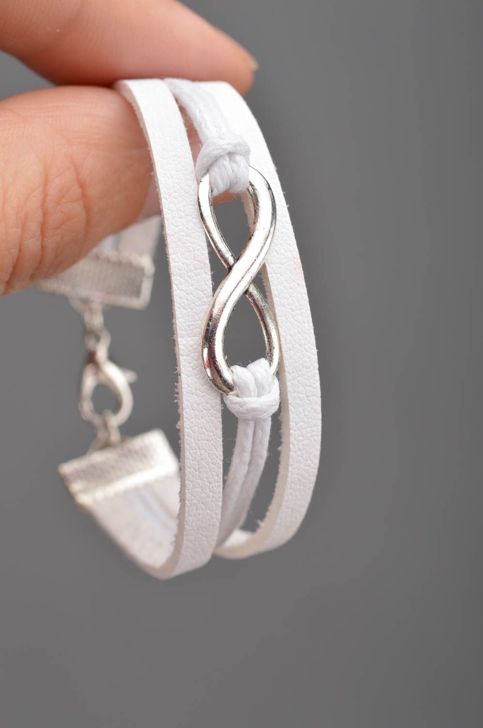 Handmade white laconic genuine leather wrist bracelet with infinity sign insert photo 1