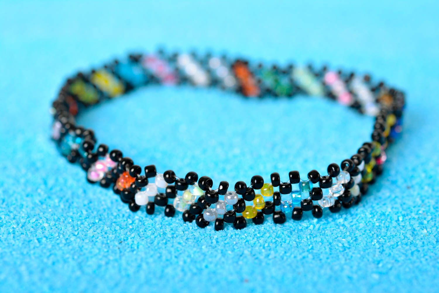 Thin handmade beaded bracelet made of black, green, red yellow beads for young girls photo 1