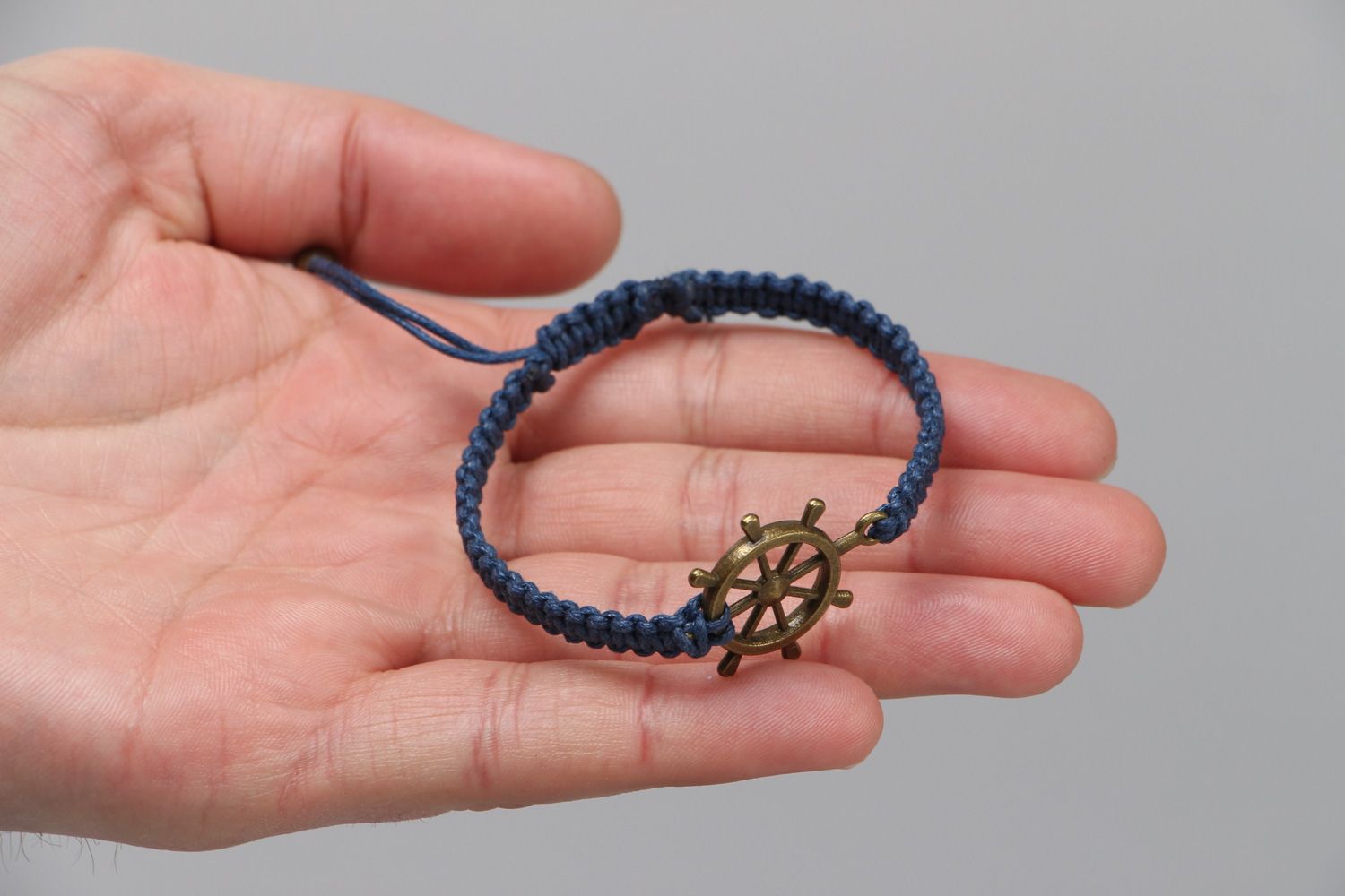 Handmade wrist bracelet woven of blue waxed cord with metal wheel unisex  photo 3