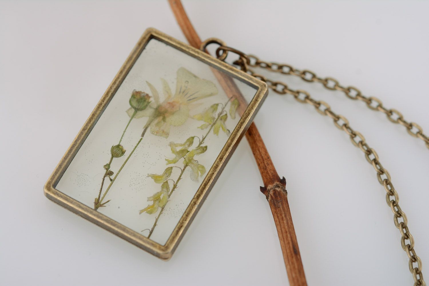 Light handmade rectangular transparent pendant with herbary in epoxy resin  photo 1