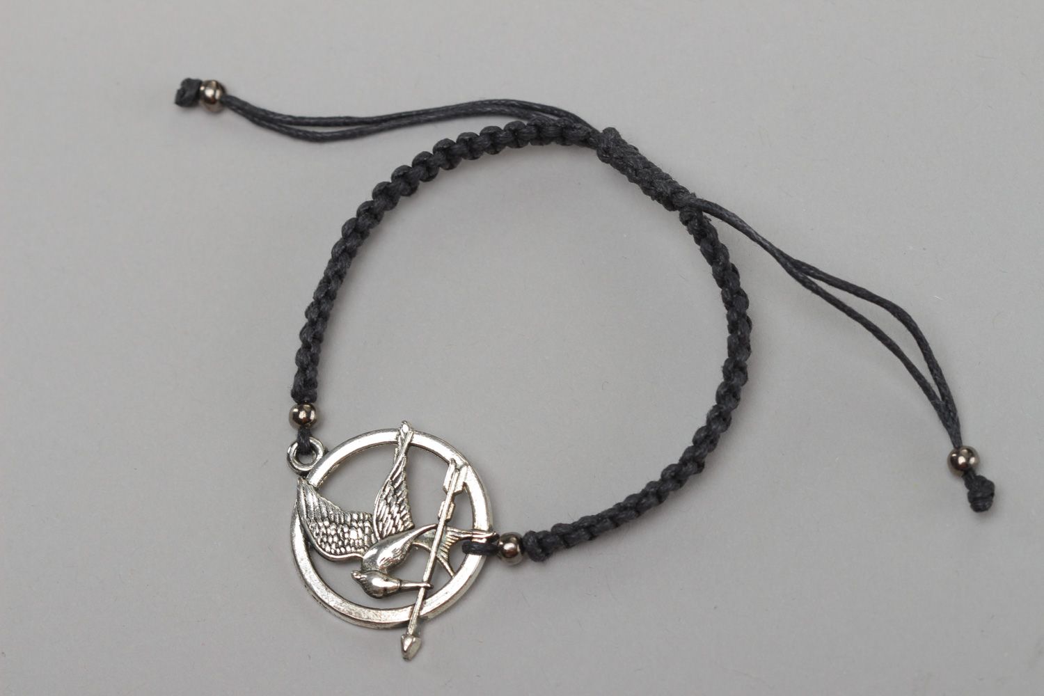 Handmade black friendship wrist bracelet woven of cord with metal charm Mokingjay photo 2
