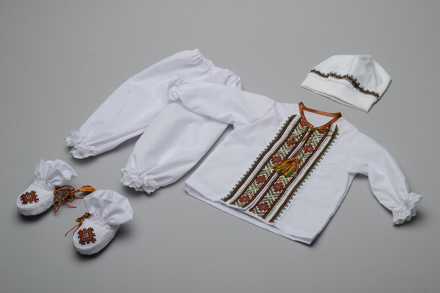 Set of handmade baby boy clothes shoes hat shirt and trousers in Ukrainian style photo 1