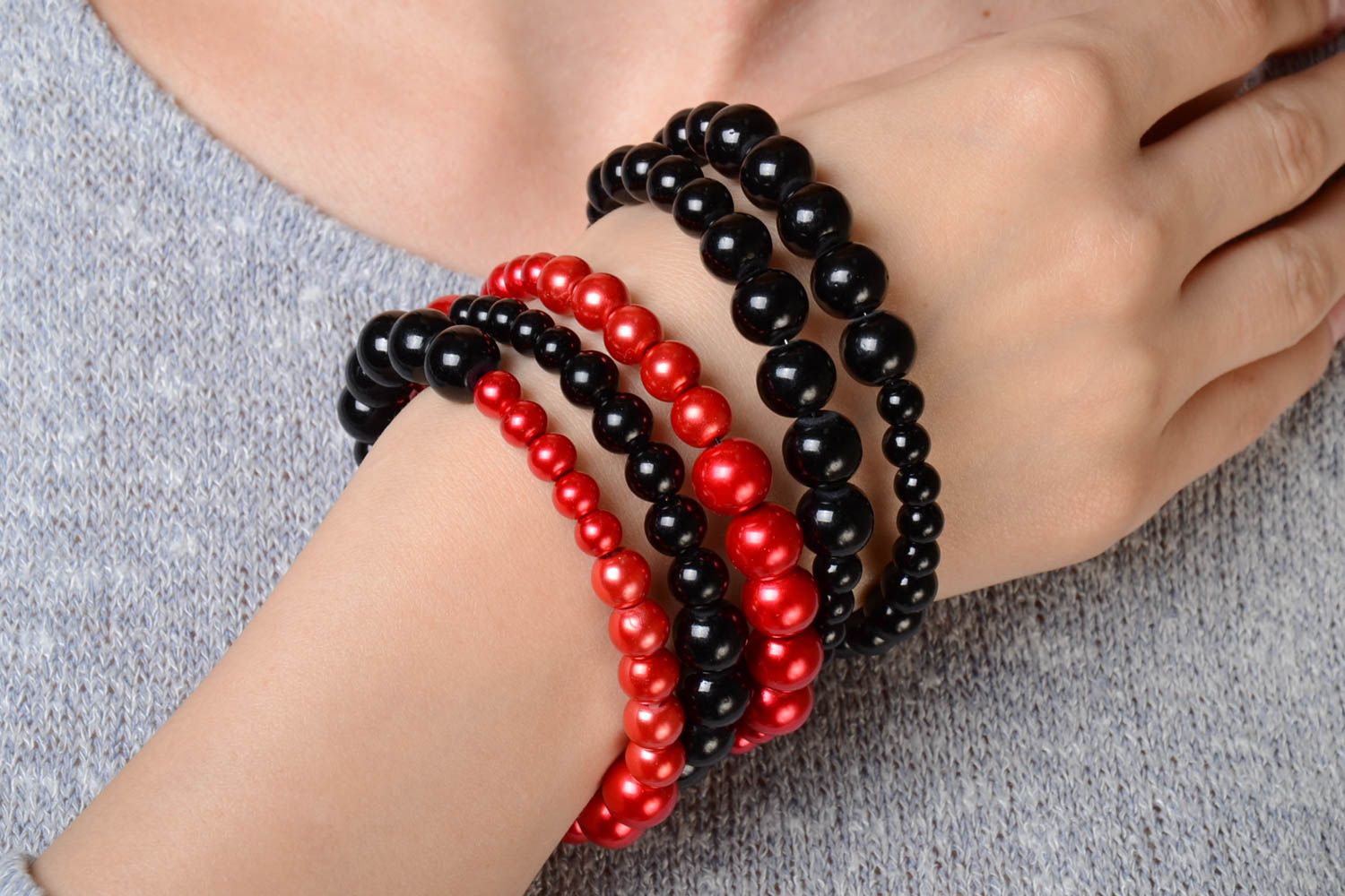 Red and black handmade designer wrist bracelet woven of plastic beads photo 1