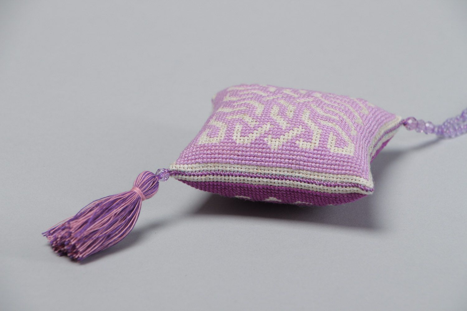 Handmade violet fabric pincushion with cross stitch embroidery and tassels photo 4