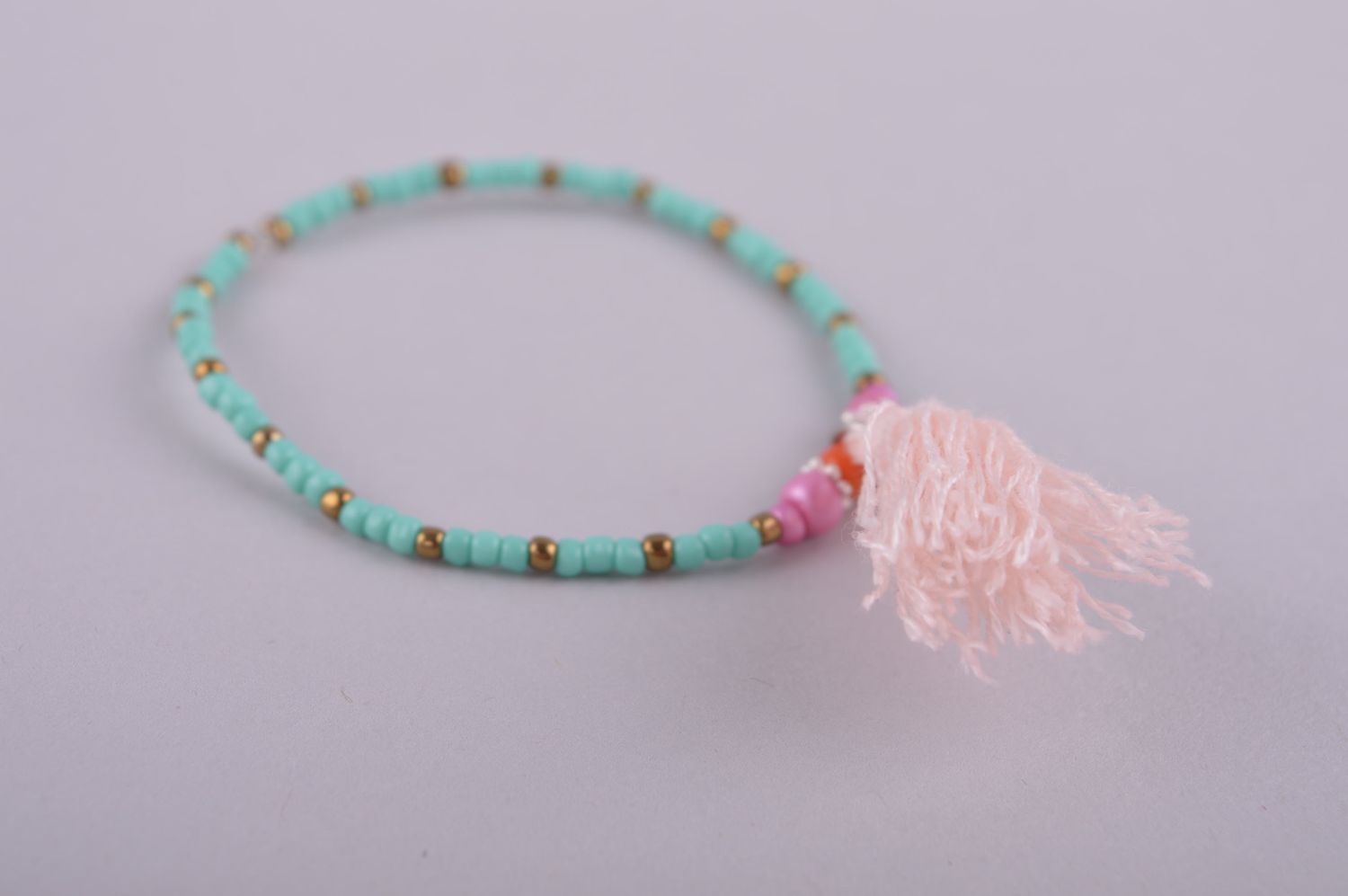 Stretch turquoise and pink handmade bracelet with a pink charm for girls photo 3