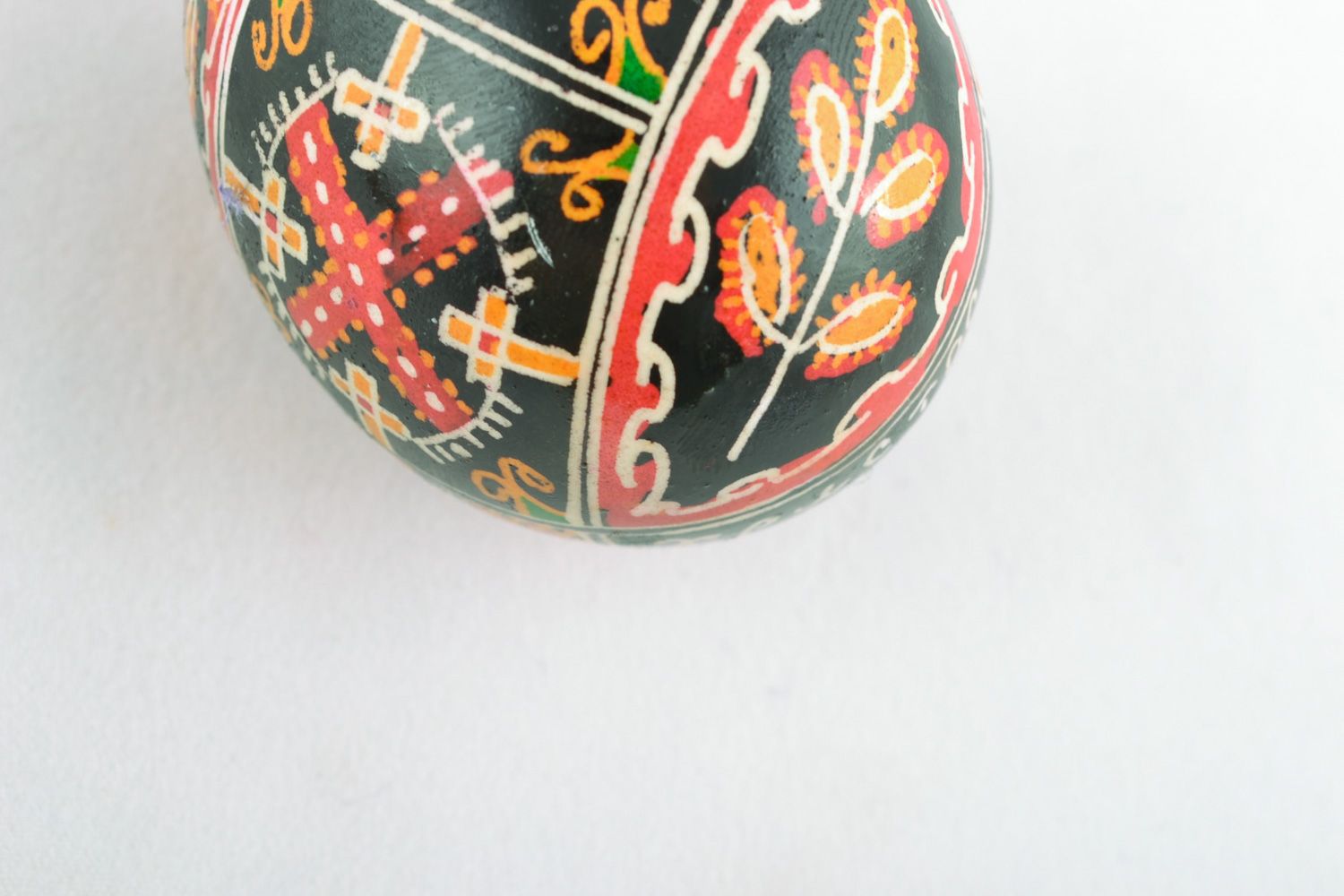 Handmade decorative painted chicken Easter egg with ornament on black background photo 4