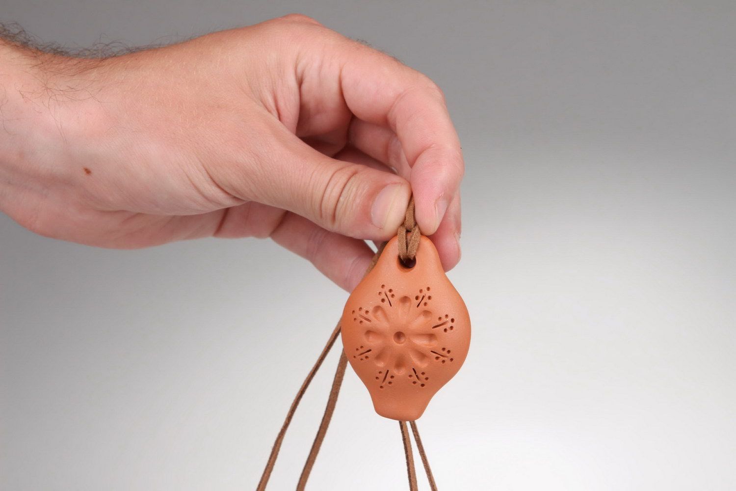 Ceramic tin whistle pendant with embossment photo 1