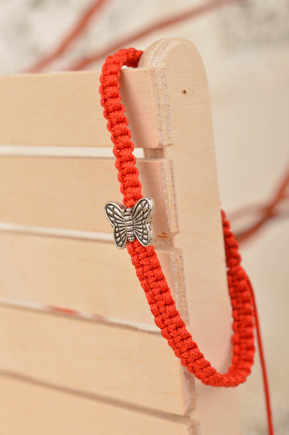 Handmade woven thin cute red bracelet made of silk threads with butterfly photo 1