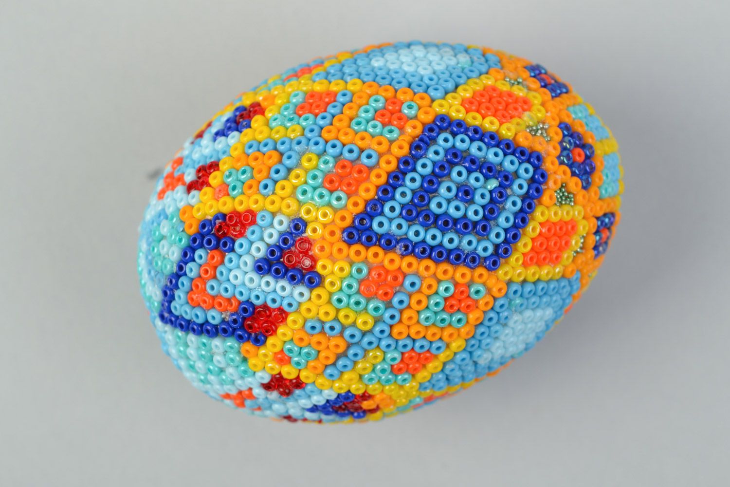 Handmade wooden multicolored Easter egg braided over with beads in Huichol style photo 3