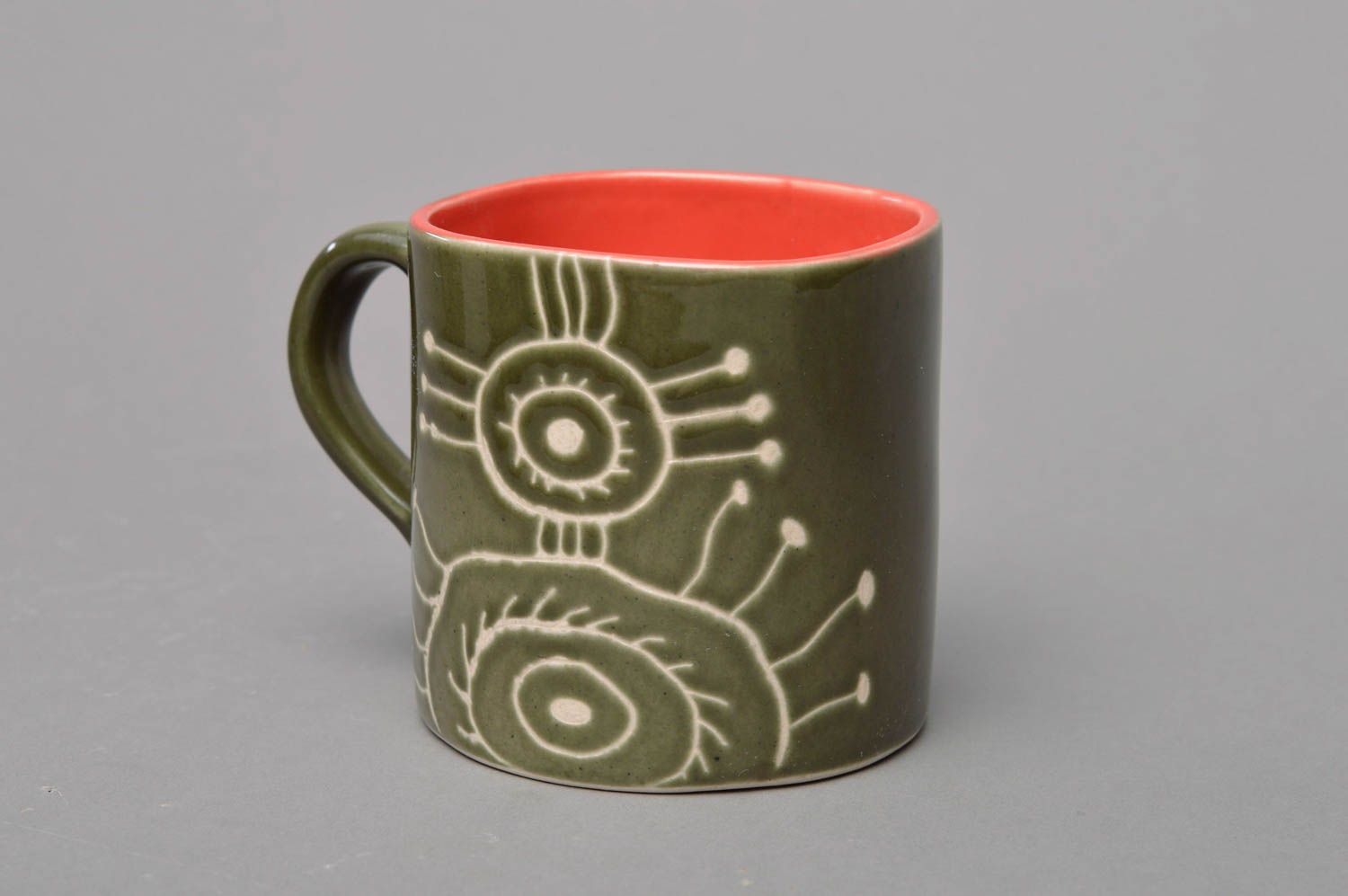 Green and orange glazed porcelain tea, coffee cup with cave drawings photo 2
