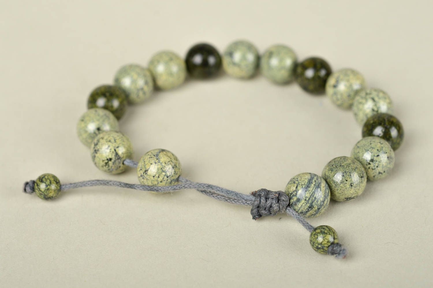 Strand pale green and black beaded bracelet on gray wax cord photo 3