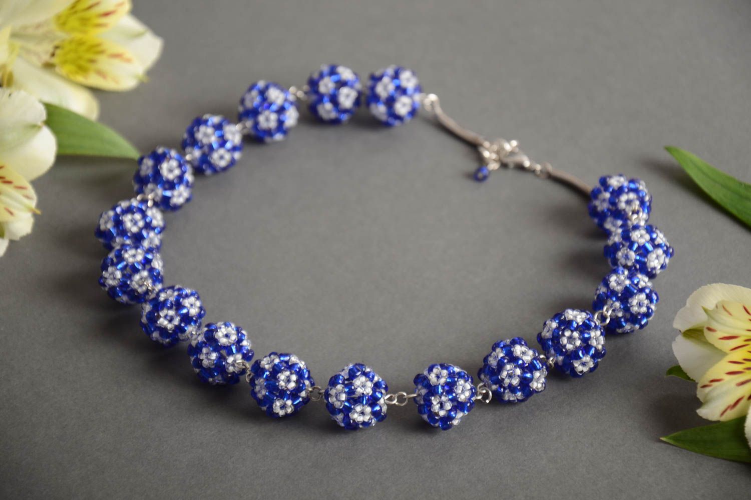 Handmade designer women's necklace with balls crocheted of blue and white beads photo 1