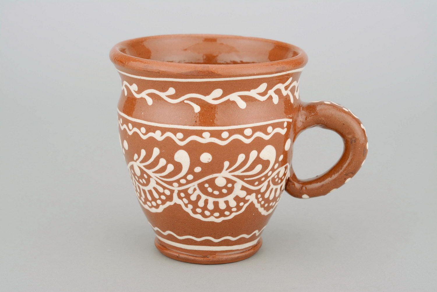 Glazed clay tea cup in terracotta color with eco pattern in white color photo 1
