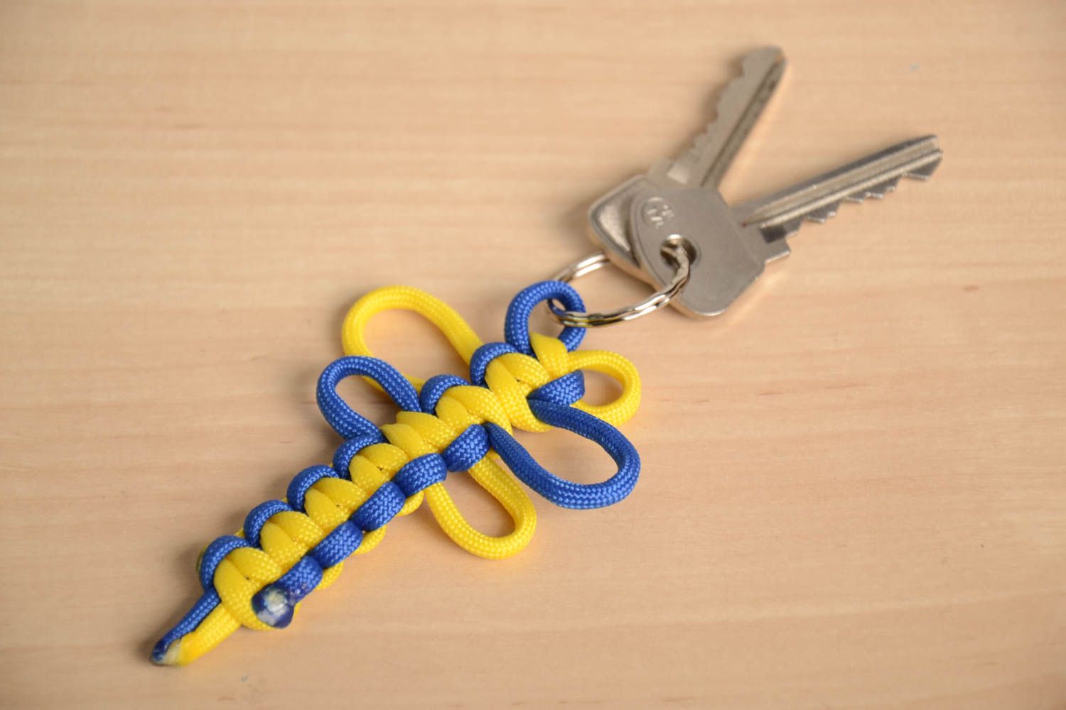 Blue and yellow handmade keychain woven of American paracord photo 1