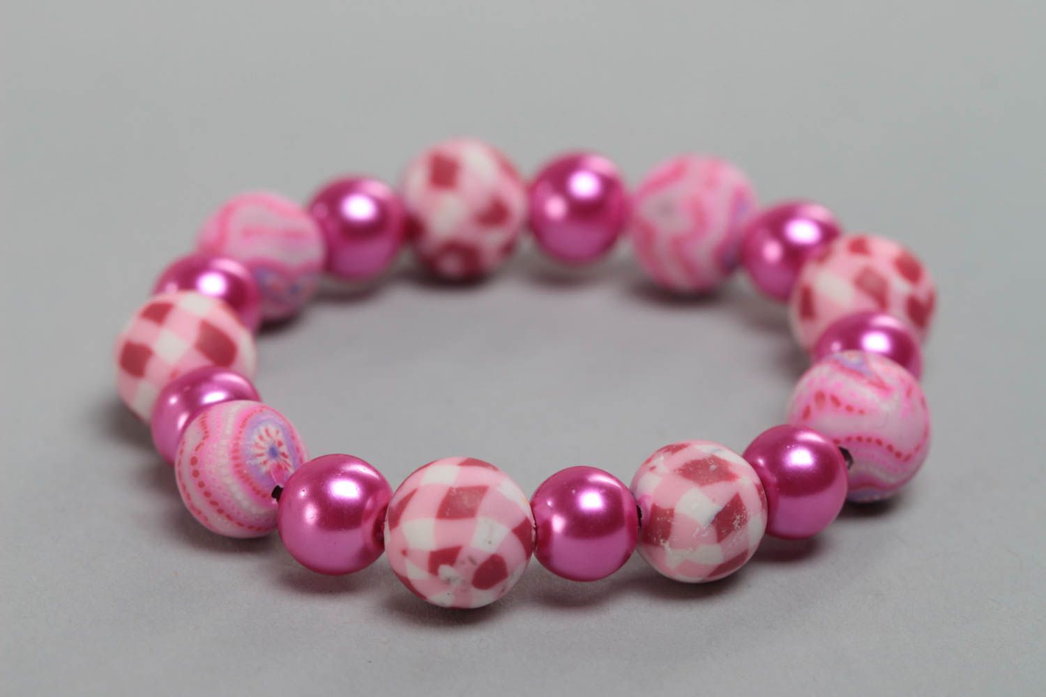Pink children's handmade designer plastic bracelet with beads on elastic band photo 2