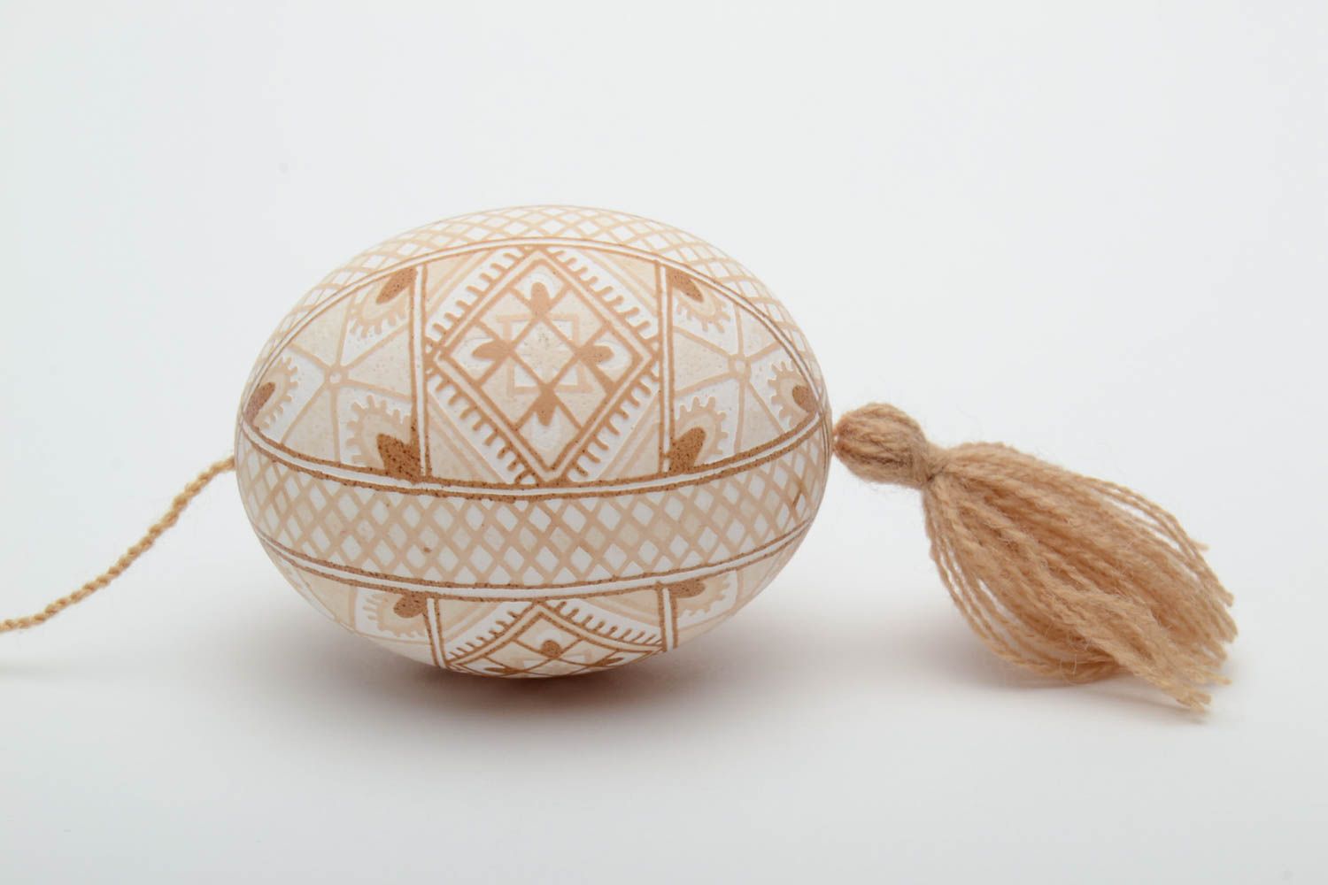 Handmade decorative light beige painted egg with geometric ornaments and tassel photo 3