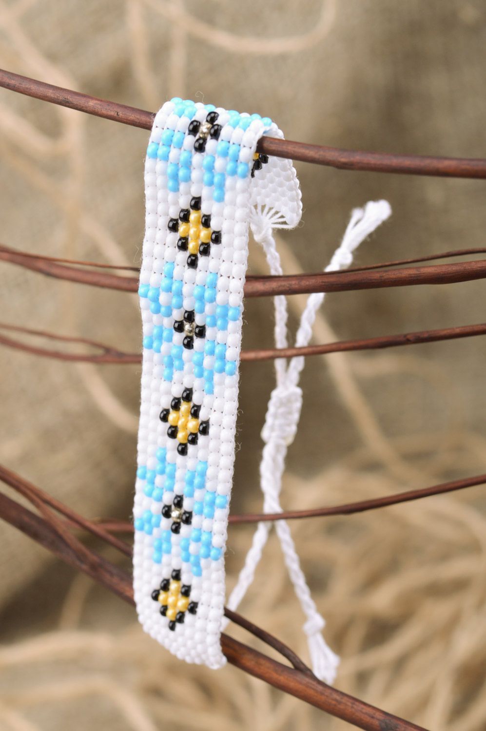 Broad handmade wrist bracelet with ethnic ornament in white and blue colors photo 1