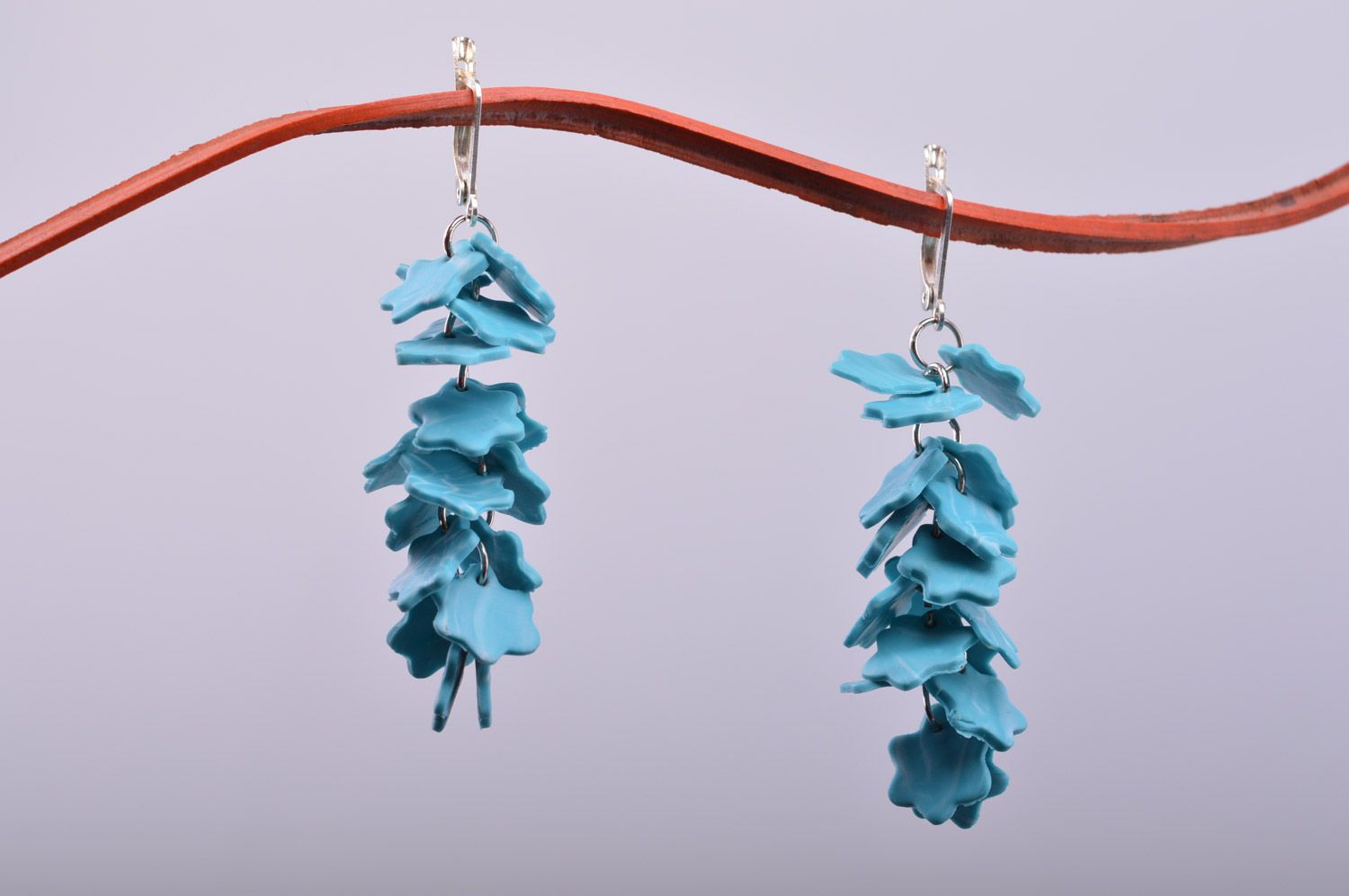 Handmade women's polymer clay flower earrings with charms in the shape of snowflakes of blue color  photo 2