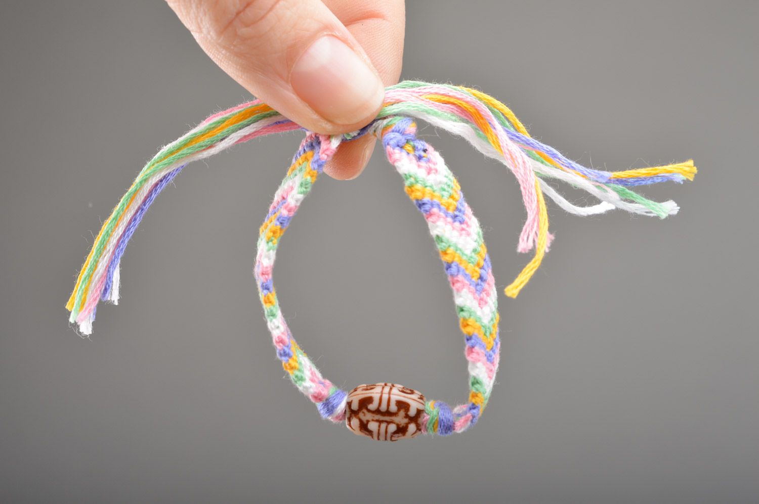 Simple handmade friendship bracelet woven of colorful embroidery floss with beads photo 3