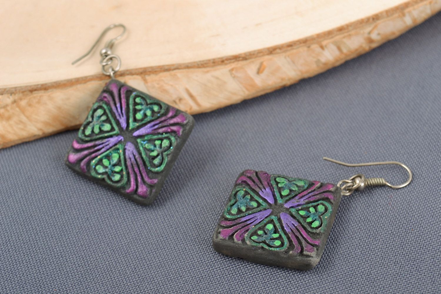 Handmade ceramic rhombus-shaped dangling earrings of black color with ornament photo 1