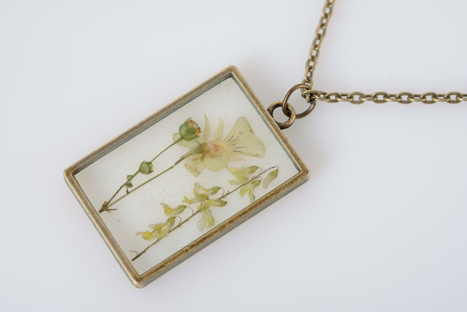 Light handmade rectangular transparent pendant with herbary in epoxy resin  photo 2