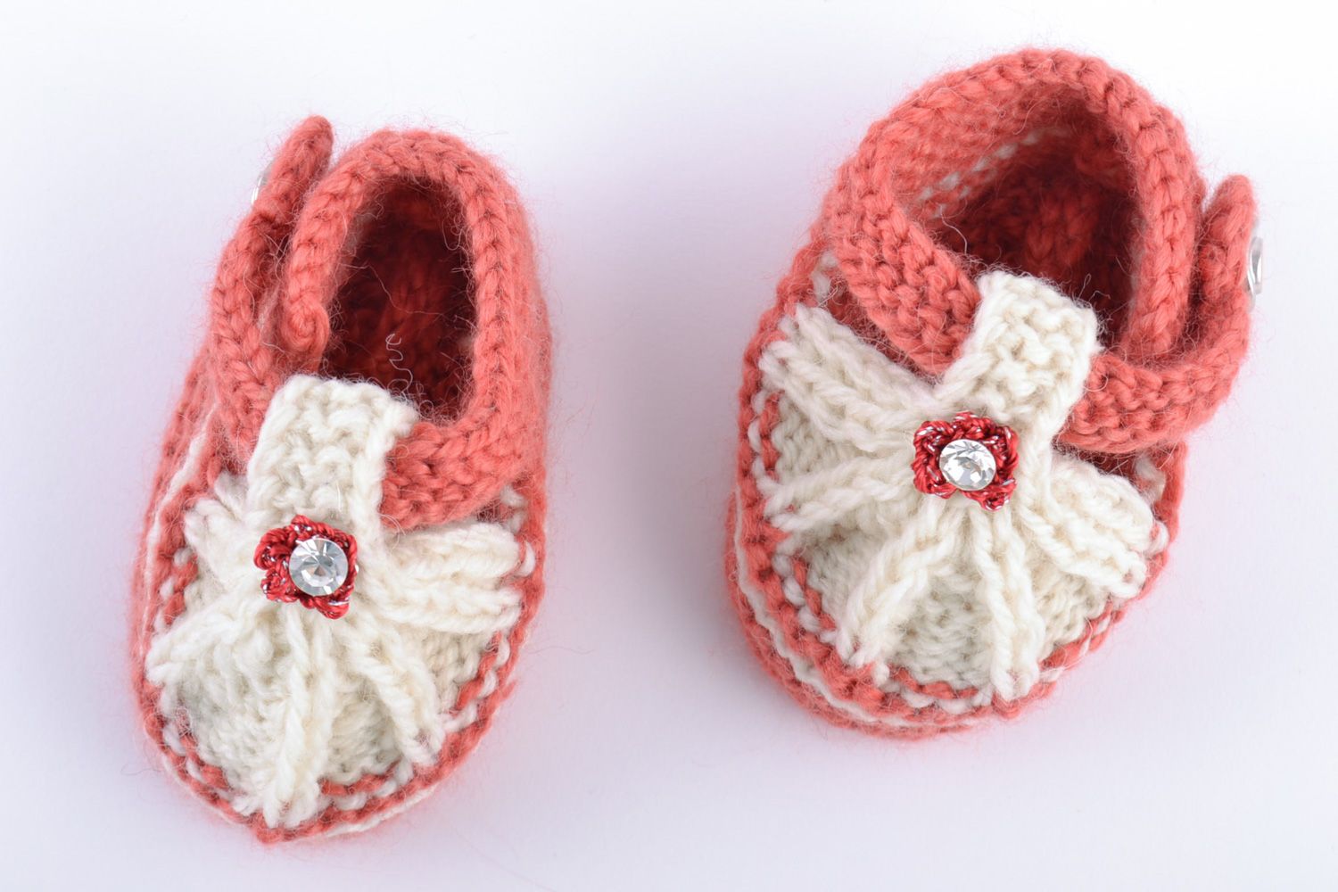 Helle weiße und rosafarbige handgemachte Babyschuhe aus Wolle in Form von Sandalen foto 2