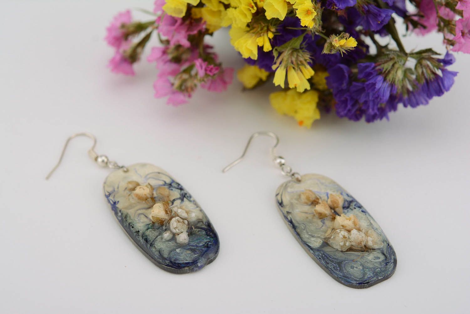 Earrings made of flowers and epoxy resin photo 1