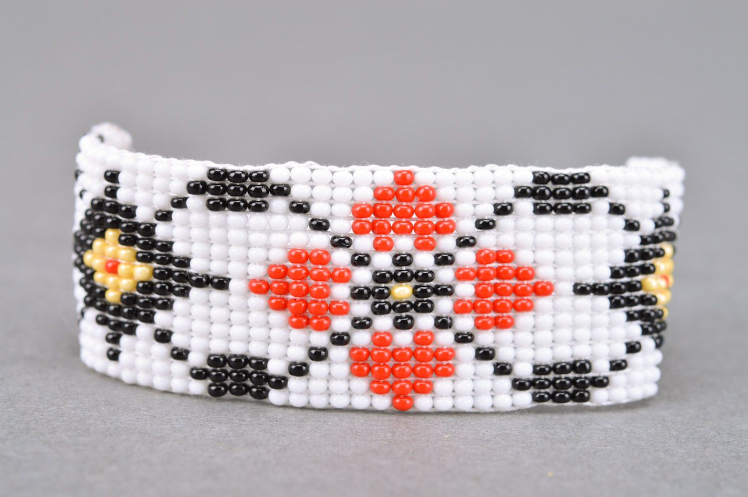 Handmade wide women's woven bead bracelet of white color with ornament photo 4