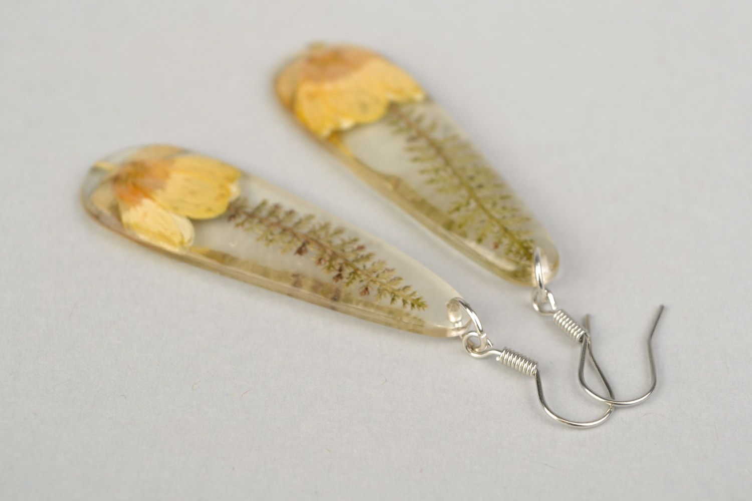 Handmade long drop-shaped dangle earrings with yellow-cup flower in epoxy resin photo 3